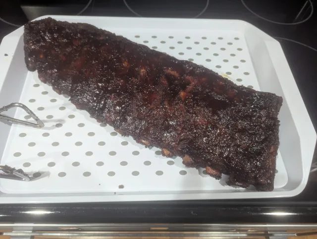 Finished St. Louis ribs with a BBQ sauce glaze, ready to serve